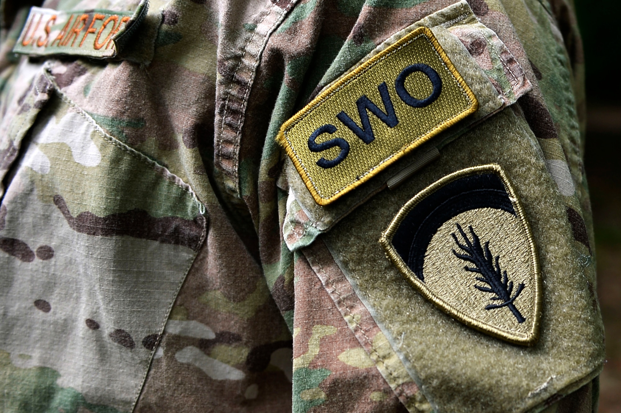 A U.S. Airman displays their staff weather officer patch at the Mainz Sand Dunes, Germany, June 13, 2017. The 7th Weather Squadron is responsible for providing weather support for U.S. Army operations in Europe. (U.S. Air Force photo by Airman 1st Class Joshua Magbanua)