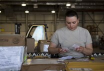 Senior Airman Cynthia Henke, 455th Expeditionary Logistics Readiness Squadron traffic management office, verifies the quantity of a product at Bagram Airfield, Afghanistan, June 13, 2017. When receiving an order, 455th ELRS TMO Airmen must verify the product, quantity, quality and recipient. (U.S. Air Force photo by Staff Sgt. Benjamin Gonsier) 