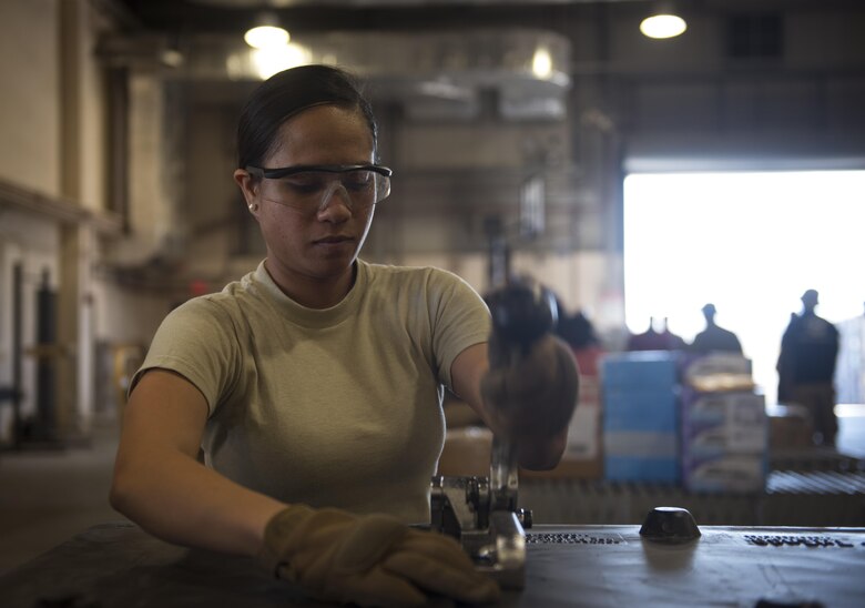 Senior Airman Zabrie Loio, 455th Expeditionary Logistics Readiness Squadron traffic management office, secures a crate at Bagram Airfield, Afghanistan, June 13, 2017. The 455th ELRS TMO receives and processes every shipment that comes through Bagram Airfield. (U.S. Air Force photo by Staff Sgt. Benjamin Gonsier) 