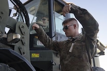 Airman 1st Class Blaine Runge directs a forklift operator, Senior Airman Giovany Tellez, both with the 455th Expeditionary Logistics Readiness Squadron traffic management office, where to unload a crate at Bagram Airfield, Afghanistan, June 13, 2017. The 455th ELRS TMO receives and processes every shipment that comes through Bagram Airfield. (U.S. Air Force photo by Staff Sgt. Benjamin Gonsier) 