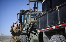 Airman 1st Class Blaine Runge directs a forklift operator, Senior Airman Giovany Tellez, both with the 455th Expeditionary Logistics Readiness Squadron traffic management office, at Bagram Airfield, Afghanistan, June 13, 2017. The 455th ELRS TMO receives vast amounts of cargo each day, and utilizes various vehicles such as forklifts and flatbed trucks to get them where they need to be. (U.S. Air Force photo by Staff Sgt. Benjamin Gonsier) 