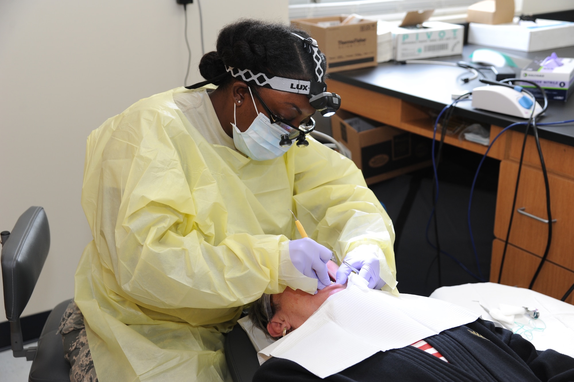 Air National Guard Tech. Sgt. Charissa Younce, dental technician, 125th Fighter Wing, Jacksonville, Florida, cleans Gayla Terdening teeth. Terdening participated in the no-cost medical services offered during the Ozark Highlands Innovated Readiness Training, Mountain Home, Arkansas, 5-12 June. (U.S. Air Force photo by Tech. Sgt. Peter Dean)  