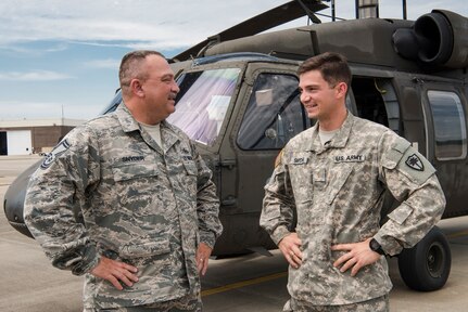U.S. Army 2nd Lt. Michael Snyder with A Co. 1-111th General Support Aviation Battalion and U.S. Air Force Senior Master Sgt. Edward Snyder with the 169th Fighter Wing pose for a photograph at McEntire Joint National Guard Base in Eastover, South Carolina, June 13, 2017. 