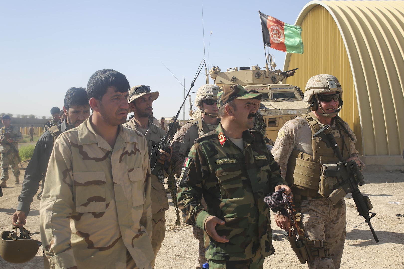 Afghan National Army Brig. Gen. Ahmadzai, center, the commanding general of the 215th Corps, and U.S. Marine Brig. Gen. Roger Turner, right, the commanding general of Task Force Southwest, speak following an advisory meeting at Camp Hanson, Afghanistan, June 13, 2017. Several Marine advisors met with their Afghan counterparts to discuss current Maiwand Three operations in Nad-e Ali and Marjah. The 215th Corps’ 1st and 3rd Brigades are currently clearing the aforementioned cities with assistance and support from Task Force Southwest. (U.S. Marine Corps photo by Sgt. Lucas Hopkins)