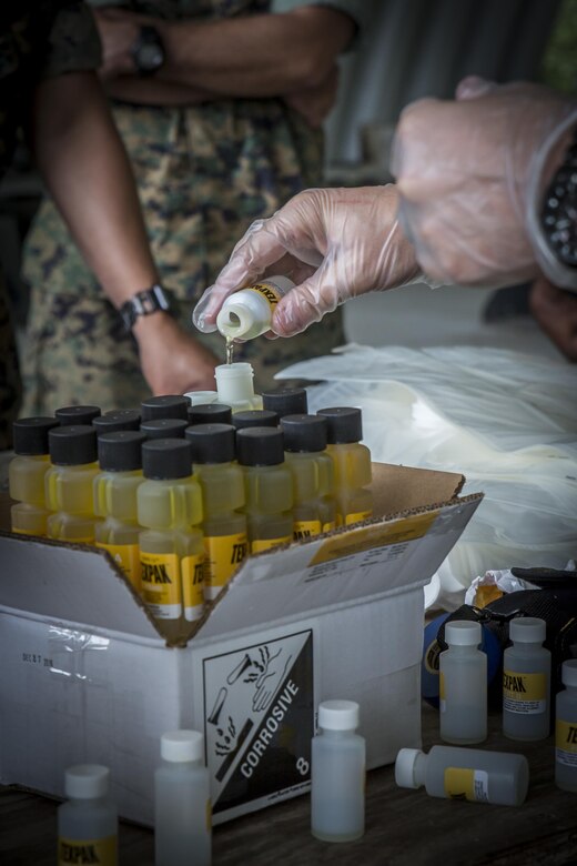 A Marine prepares a liquid binary explosive called TEXPAK during demolition exercise at the Explosive Ordnance Range aboard Marine Corps Air Station Beaufort, June 1. The MCAS Beaufort EOD Marines conducted the demolition exercise to detonate unused TEXPAK explosives left over from the 2017 MCAS Beaufort Air Show and to practice for future air shows. The Marine is an EOD technician with EOD, MCAS Beaufort.