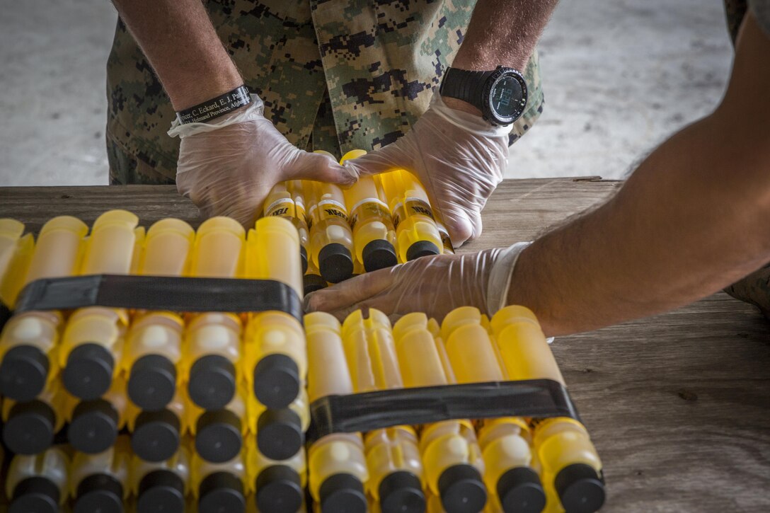 Marines tape a liquid binary explosive called TEXPAK together during demolition exercise at the Explosive Ordnance Range aboard Marine Corps Air Station Beaufort, June 1. The MCAS Beaufort EOD Marines conducted the demolition exercise to detonate unused  explosives  from  the  2017  MCAS  Beaufort  Air  Show  using  the  opportunity  to  practice  for  future  air  shows.  The  Marines  are  EOD  technicians  with  EOD,  MCAS  Beaufort.