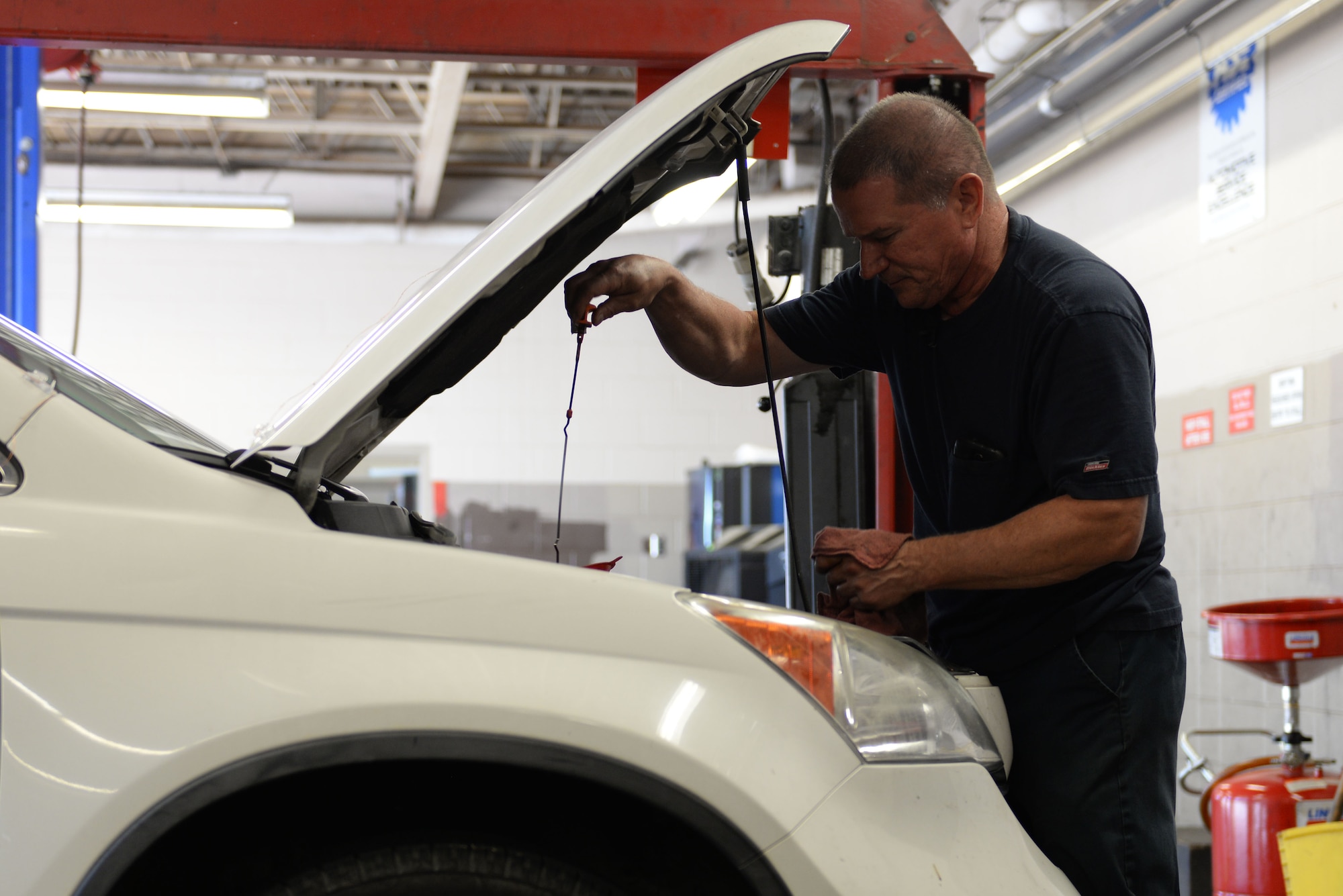 Thomas Johnson, 19th Force Support Squadron Auto Hobby Shop lead mechanic, checks oil levels for a customer’s car June 9, 2017, at Little Rock Air Force Base, Ark. Classes on general maintenance are available at the Auto Hobby Shop, once a month. (U.S. Air Force photo by Airman Rhett Isbell)