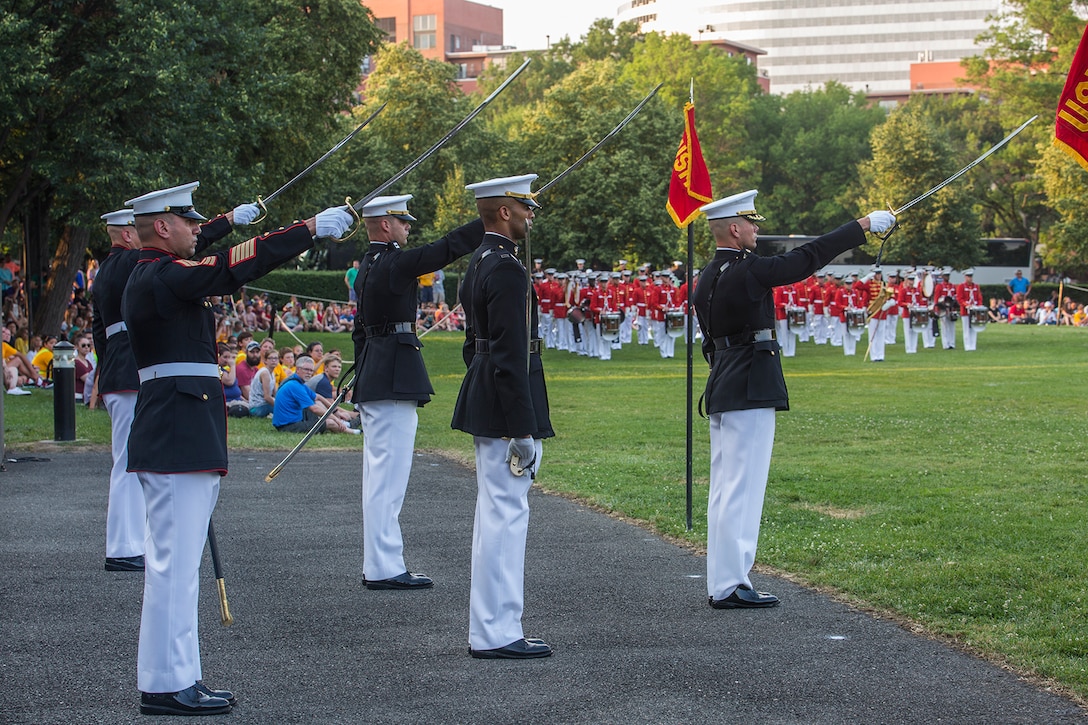 Marines of the parade staff execute “draw sword” during a Tuesday Sunset Parade at the Marine Corps War Memorial, Arlington, Va., June 13, 2017. The guest of honor for the parade was the Honorable Marcy Kaptur, U.S. Representative from the 9th Congressional District of Ohio, and the hosting official was Lt. Gen. Gary Thomas, deputy commandant, Programs and Resources. (Official U.S. Marine Corps photo by Cpl. Robert Knapp/Released)