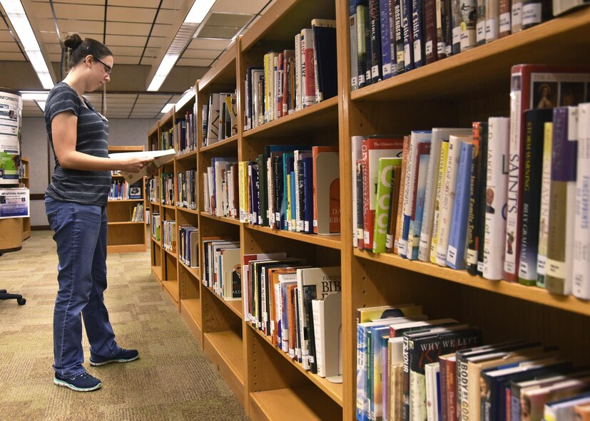 Patti Cantrell, 325th Force Support library volunteer, examines books at the Tyndall Air Force Base, Fla., library June 9, 2017. Beginning June 22 at 11:30 a.m. and ending July 27, the Tyndall library will be holding their weekly Summer Reading Program events every Thursday from 11:30 a.m to 1:00 p.m. (U.S. Air Force photo by Senior Airman Sergio A. Gamboa/Released)