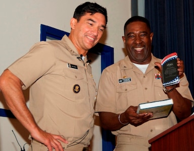 DAHLGREN, Va. - Capt. Godfrey "Gus" Weekes, Naval Surface Warfare Center Dahlgren Division (NSWCDD) commanding officer, presents the Dahlgren history book, "The Sound of Freedom," and a plaque to Rear Adm. Patrick Piercey, Naval Surface Force Atlantic commander, at the NSWCDD sponsored Asian American and Pacific Islander Heritage Month Observance, May 23. "We are united by our love of freedom and love of the values that we have as Americans despite what source you came in to become an American," said Piercey. "We are celebrating diversity without being divisive and recognizing that we are truly stronger because of our diversity."