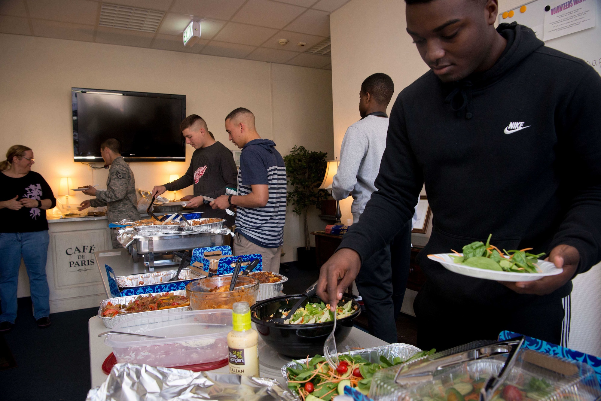 Airmen participate in a Friday night free meal at Club 7 on Ramstein Air Base, June 10, 2017. Run by the 86th Airlift Wing Chapel, the Ramstein Club 7 offers junior enlisted Airmen a number of services, including free meals starting at 6:00 p.m. every Friday, and free resiliency trips that include activities like snowboarding and sky diving. (U.S. Air Force photo by Senior Airman Elizabeth Baker)