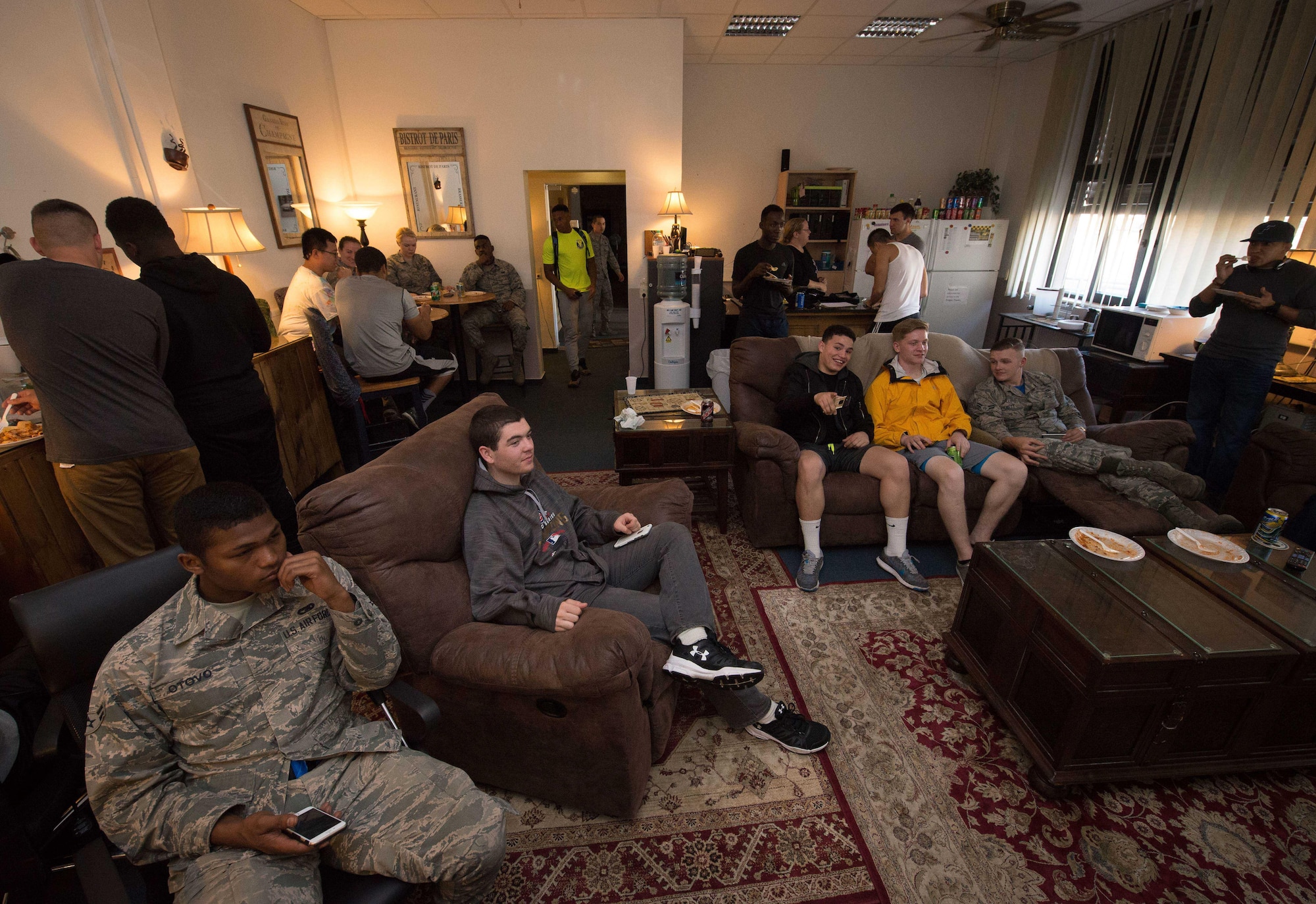 Airmen eat, socialize, and watch a movie at Club 7 on Ramstein Air Base, June 10, 2017. Run by the 86th Airlift Wing Chapel, Club 7 is designed to encourage morale and friendship by inviting junior enlisted Airmen to come and enjoy services such as videogames, Wi-Fi and food. (U.S. Air Force photo by Senior Airman Elizabeth Baker)