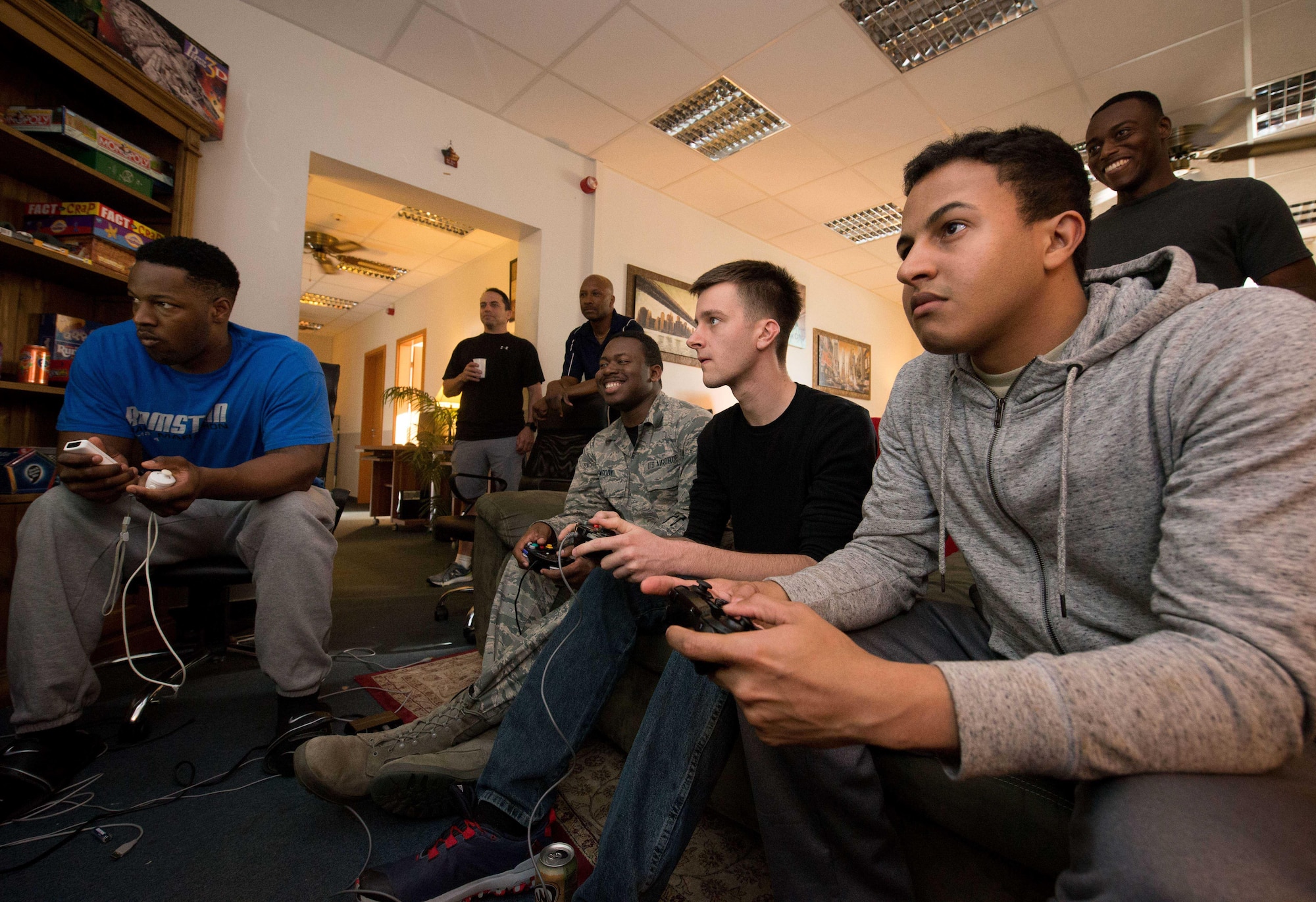 Airmen play in the game room at Club 7 on Ramstein Air Base, June 10, 2017. The 86th Airlift Wing Chapel’s Airmen Ministry Center runs Club 7 locations on Ramstein and Kapaun Air Station with the goal of providing junior enlisted Airmen a safe “home away from home” atmosphere where they can relax and make friends. (U.S. Air Force photo by Senior Airman Elizabeth Baker)