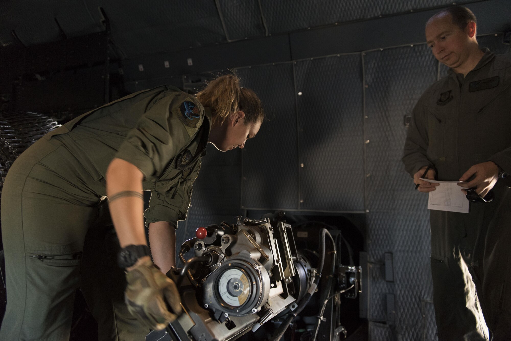 Staff Sgt. Erin Denney, 551st Special Operations Squadron aerial gunner student, inspects a 30mm gun aboard an AC-130W Stinger II gunship at Cannon Air Force Base, New Mexico, June 13, 2017. Denny was being evaluated during the live-fire training mission. (U.S. Air Force photo by Staff Sgt. Michael Washburn/Released)