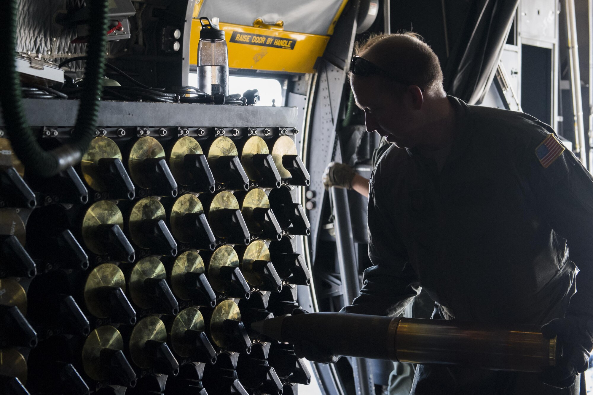 Tech. Sgt. William Sell, 551st Special Operations Squadron aerial gunner evaluator, loads a 105mm round into an ammunition rack aboard an AC-130W Stinger II gunship at Cannon Air Force Base, New Mexico, June 13, 2017. Before loading the round into the ammo rack, Sell performs a quick inspection to ensure it’s not damaged in any way. (U.S. Air Force photo by Staff Sgt. Michael Washburn/Released)