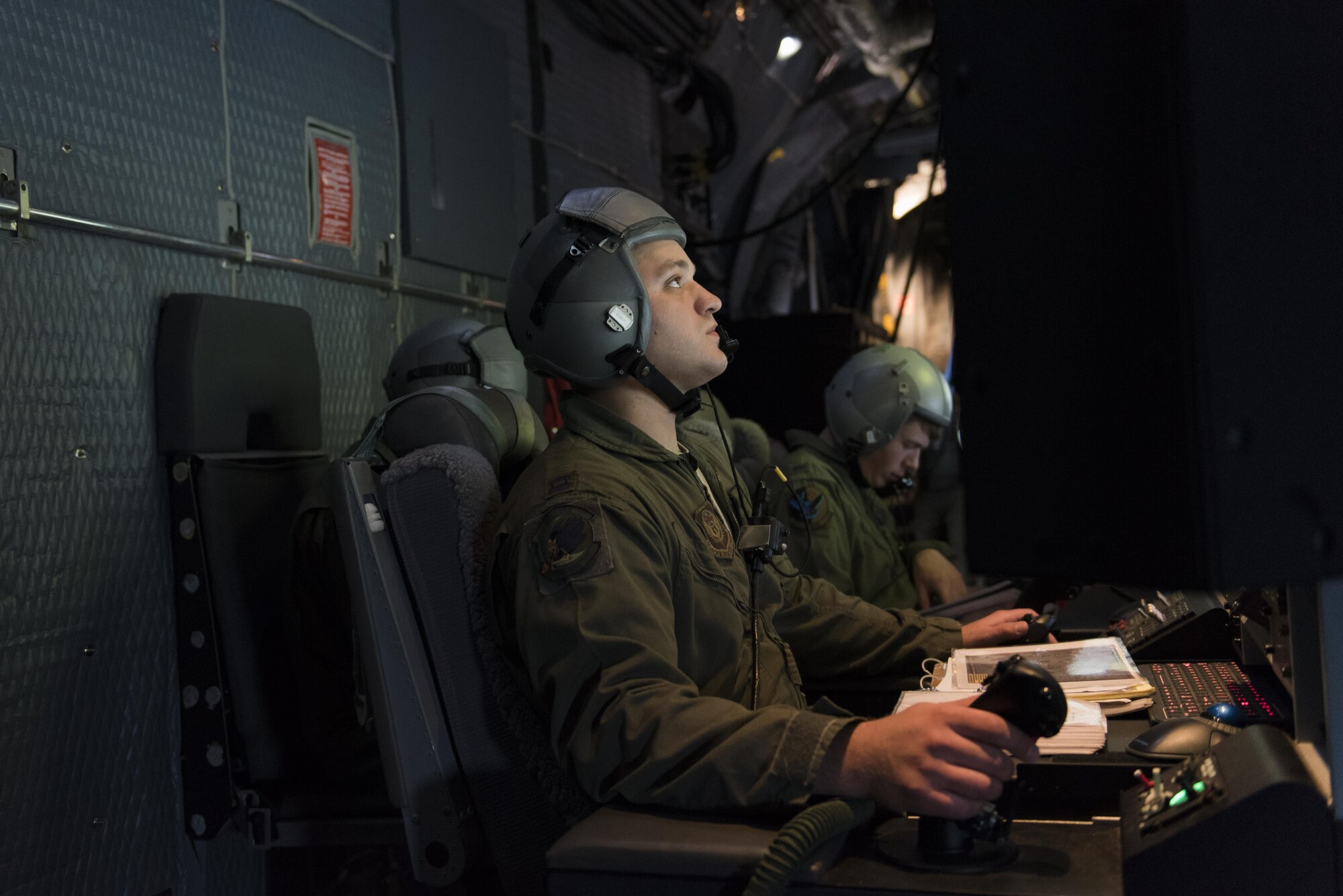 Capt. Brian Burt, 16th Special Operations Squadron combat systems officer, observes the situation on the ground through multiple screens at the mission operators pallet aboard an AC-130W Stinger II at Cannon Air Force Base, New Mexico, June 13, 2017. At the MOP, Burt can operate the 30mm and 105mm guns on the aircraft. (U.S. Air Force photo by Staff Sgt. Michael Washburn/Released)