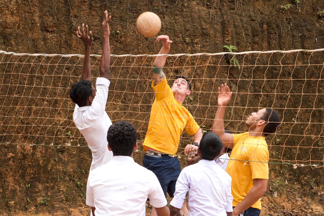 Sailors from the USS Lake Erie play volleyball with students at the Kalutara-Molkawa School near Kalutara, Sri Lanka, June 15, 2017. The event was part of a community engagement in support of humanitarian assistance operations in the wake of  recent heavy rainfall brought by a southwest monsoon that triggered flooding and landslides throughout the country, displacing thousands of people and causing significant damage to homes and buildings. Navy photo by Petty Officer 2nd Class Joshua Fulton