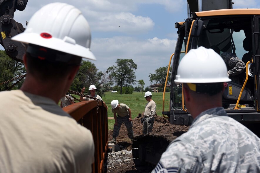 Twenty-second Civil Engineer Squadron Airmen align a bridge June 14, 2017 at the Kruger Recreational 2-mile track on McConnell Air Force Base, Kan. The 22nd CES plays a critical role in maintaining the base’s facilities and structures. (U.S. Air Force photo/Airman 1st Class Alan Ricker)