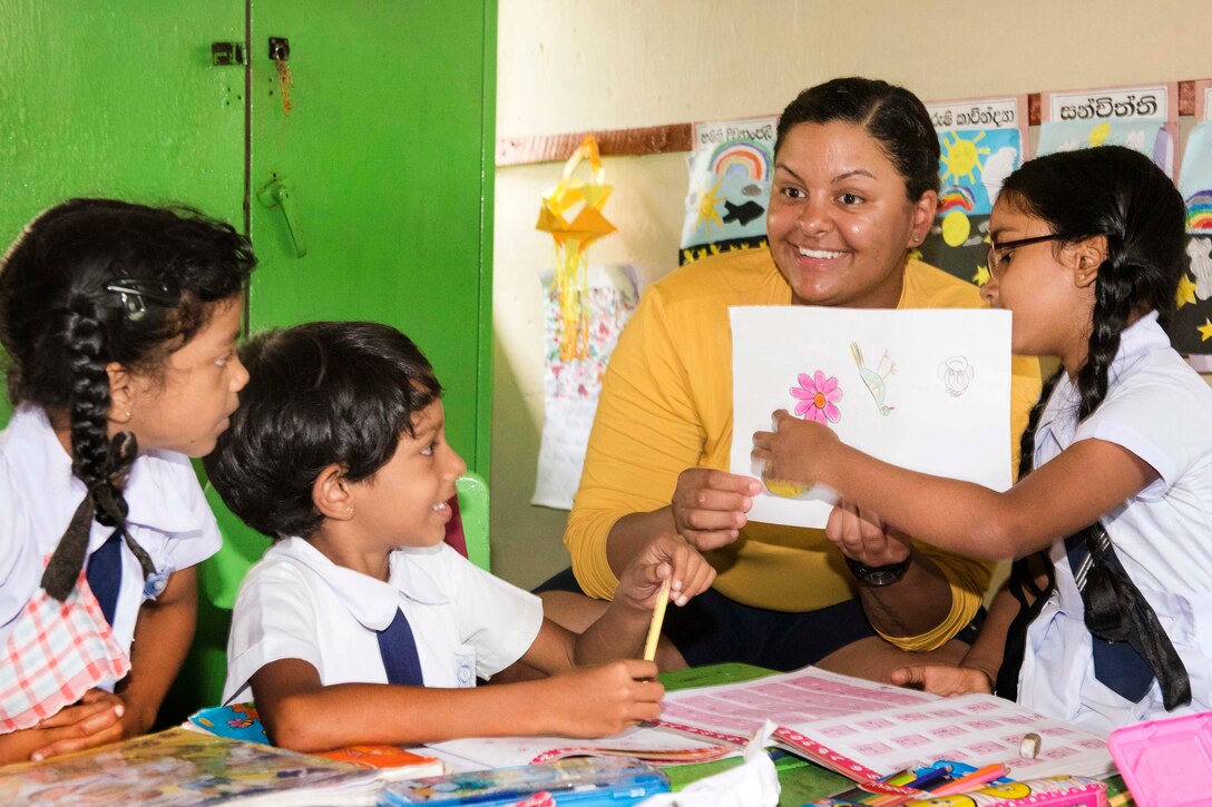 Navy Petty Officer 3rd Class Julia Robinson draws some flowers with students at the Kalutara-Molkawa School near Kalutara, Sri Lanka, June 15, 2017, during a community engagement event in support of humanitarian assistance operations in the wake of severe flooding and landslides that devastated many regions of the country. Robinson is a fire controlman. Navy photo by Petty Officer 2nd Class Joshua Fulton