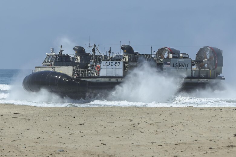 A Landing Craft Air Cushion, with 15th Marine Expeditionary Unit, lands at Red Beach during the Marine Air- Ground Task Force demonstration for the 75th Anniversary on Camp Pendleton, Calif., June 14, 2017. The demonstration allowed civilians to observe Marines as they recertified their qualifications before deployment. (U. S. Marine Corps photo by Lance Cpl. Betzabeth Y. Galvan)