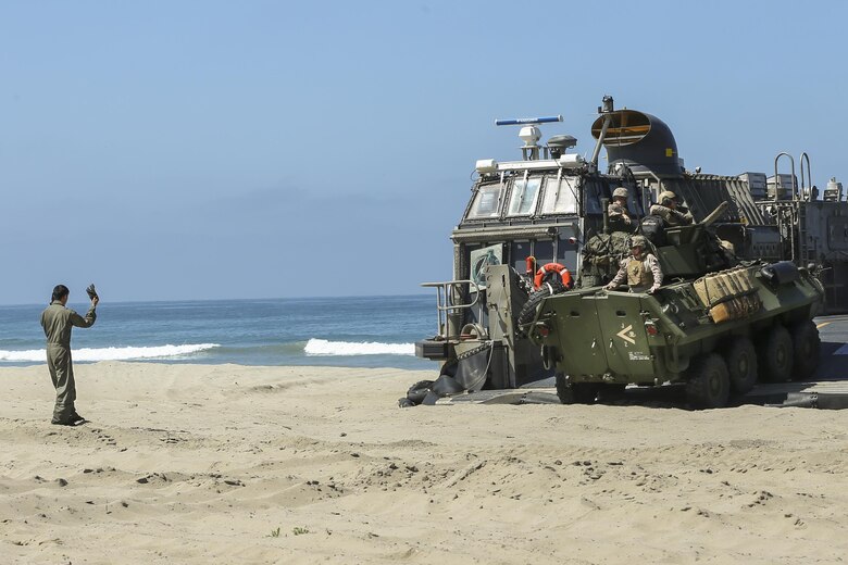 A Light Armored Vehicle, with 15th Marine Expeditionary Unit, departs the Landing Craft Air Cushion on Red Beach during the Marine Air- Ground Task Force demonstration for the 75th Anniversary on Camp Pendleton, Calif., June 14, 2017. The demonstration allowed civilians to observe Marines as they recertified their qualifications before deployment. (U. S. Marine Corps photo by Lance Cpl. Betzabeth Y. Galvan)