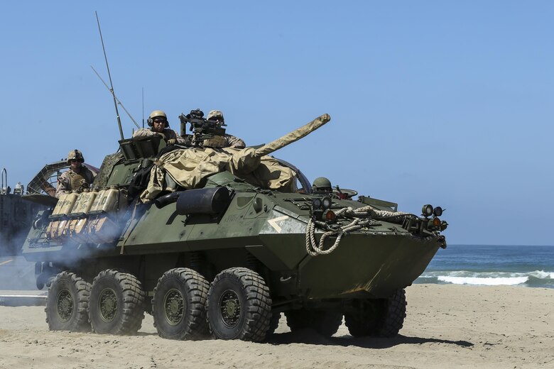 A Light Armored Vehicle, with 15th Marine Expeditionary Unit, moves to the static display area for the guests to view at Red Beach during the Marine Air- Ground Task Force demonstration for the 75th Anniversary on Camp Pendleton, Calif., June 14, 2017. The demonstration allowed civilians to observe Marines as they recertified their qualifications before deployment. (U. S. Marine Corps photo by Lance Cpl. Betzabeth Y. Galvan)