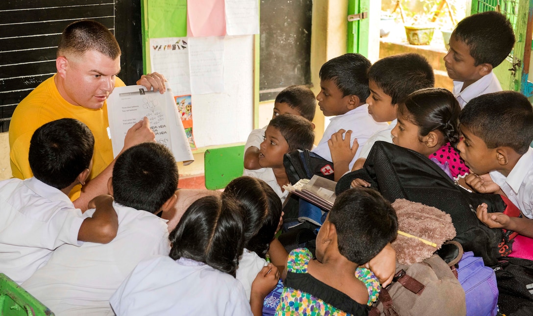 Navy Chief Petty Officer Daniel Jacobs interacts with students at the Kalutara-Molkawa School near Kalutara, Sri Lanka, June 15, 2017, during a community engagement event in support of humanitarian assistance operations in the wake of severe flooding and landslides. Jacobs is chief cryptologic technician. Navy photo by Petty Officer 2nd Class Joshua Fulton