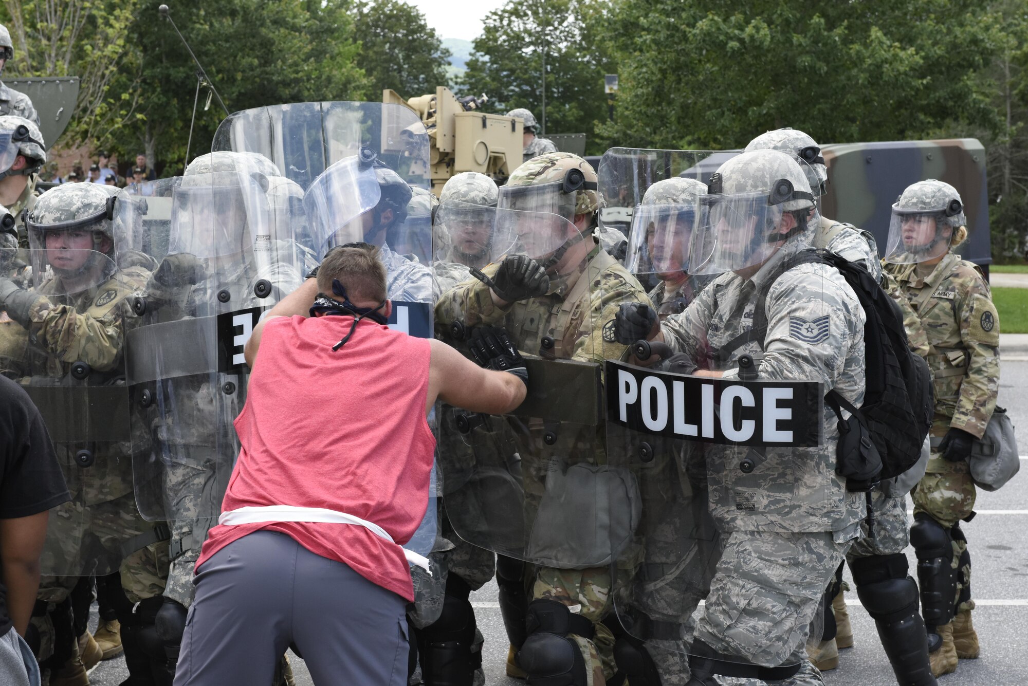 U.S. Air Force Tech. Sgt. Shane Johnson (right) holds back mock protestors at a simulated riot for Vigilant Catamount at Western Carolina University, Cullowhee North Carolina, June 13, 2017. Vigilant Catamount is a mulitday, multi-agency training exercise ending with simulated riot at Western Carolina University, involving Army National Guard Military police and the 145th Airlift Wing Security Forces.