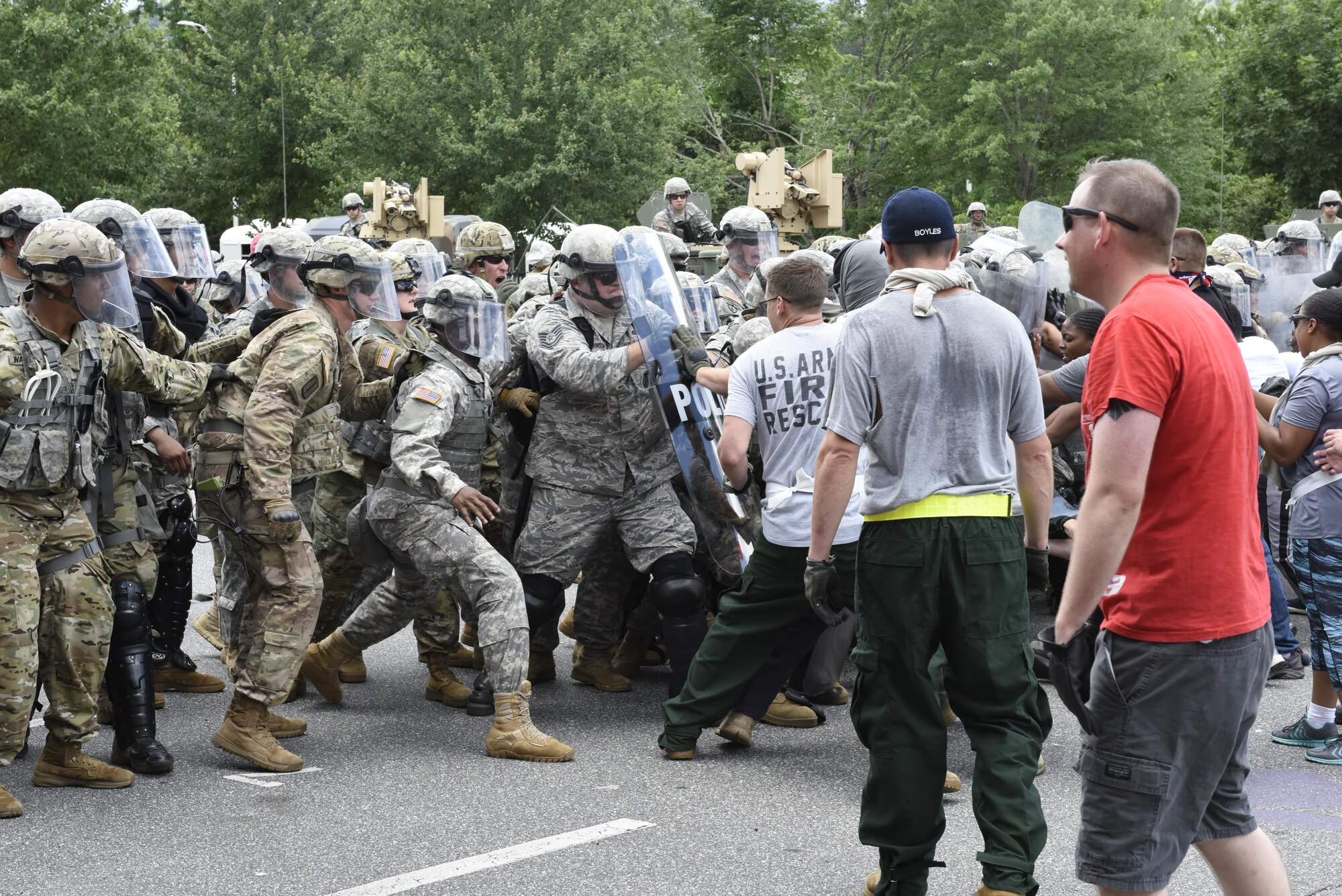 U.S. Air Force Tech. Sgt. Shane Johnson holds back mock protestors at a simulated riot for Vigilant Catamount at Western Carolina University, Cullowhee North Carolina, June 13, 2017. Vigilant Catamount is a mulitday, multi-agency training exercise ending with simulated riot at Western Carolina University, involving Army National Guard Military police and the 145th Airlift Wing Security Forces.