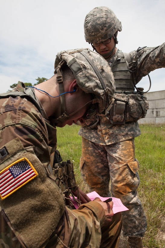 Cpl. Carlo Deldonno, with the 804th Medical Brigade, grades Cpl. Janmichael Armijo, with the 35th Expeditionary Sustainment Brigade, 1st Mission Support Command, his M9 target at the 2017 U.S. Army Reserve Best Warrior Competition at Fort Bragg, N.C., June 13. This year's Best Warrior Competition will determine the top noncommissioned officer and junior enlisted Soldier who will represent the U.S. Army Reserve in the Department of the Army Best Warrior Competition later this year at Fort A.P. Hill, Va. (U.S. Army Reserve photo by Lisa Velazco) (Released)