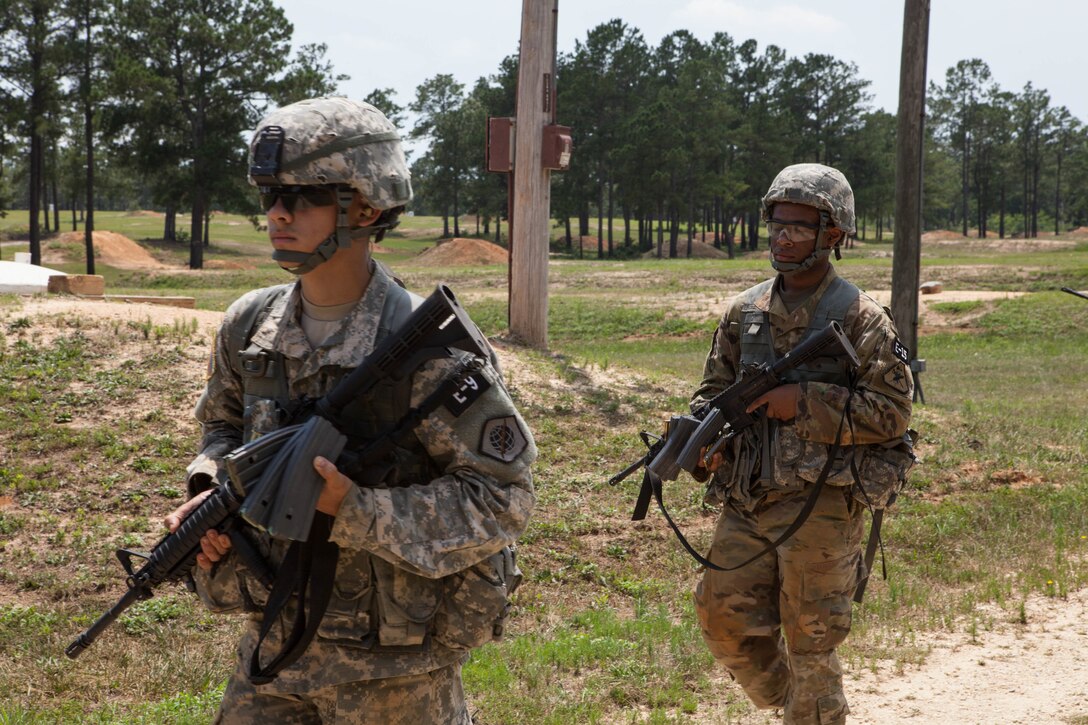 Spc. Julian Ditona, with C Company, 98th Expeditionary Signal Battalion, and Pfc. Andrew Green, with the 6th Legal Operations Detachment, walk off the range at the 2017 U.S. Army Reserve Best Warrior Competition at Fort Bragg, N.C., June 13. This year's Best Warrior Competition will determine the top noncommissioned officer and junior enlisted Soldier who will represent the U.S. Army Reserve in the Department of the Army Best Warrior Competition later this year at Fort A.P. Hill, Va. (U.S. Army Reserve photo by Lisa Velazco) (Released)