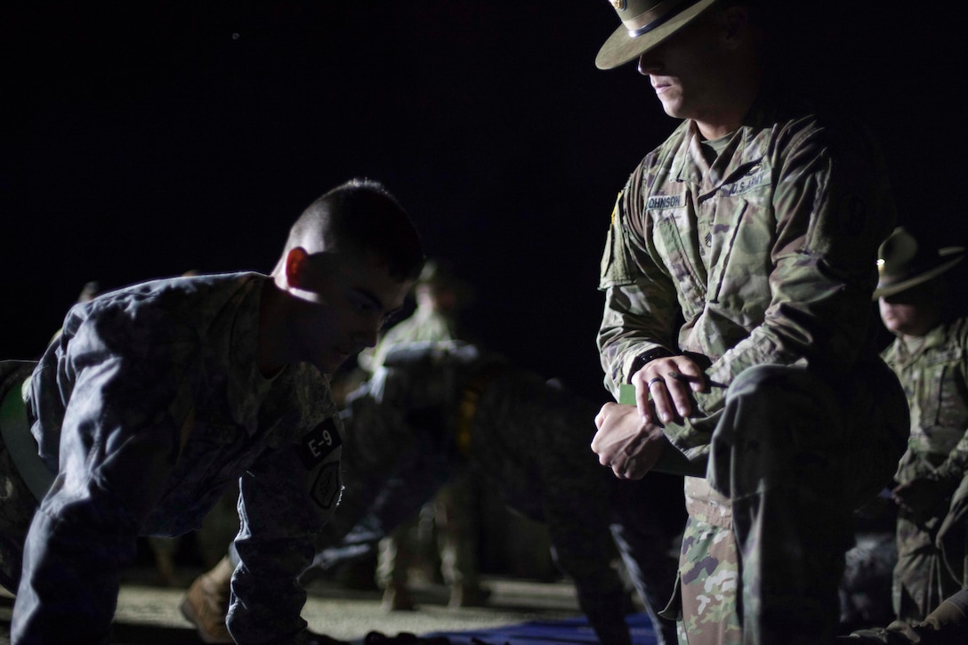 Staff Sgt. James Johnson, a drill sergeant with A Company 1-354 Training Battalion, grades Spc. Julian Ditona, a Multichannel Tranmission Systems Operator-Maintainer repesenting  C Company, 335th Signal Command (Theatre), 98th Expeditionary Signal Battalion, conducting push-ups, at the 2017 U.S. Army Reserve Best Warrior Competition at Fort Bragg, N.C., June 13. This year's Best Warrior Competition will determine the top noncommissioned officer and junior enlisted Soldier who will represent the U.S. Army Reserve in the Department of the Army Best Warrior Competition later this year at Fort A.P. Hill, Va. (U.S. Army Reserve photo by Spc. Jesse L. Artis Jr.) (Released)