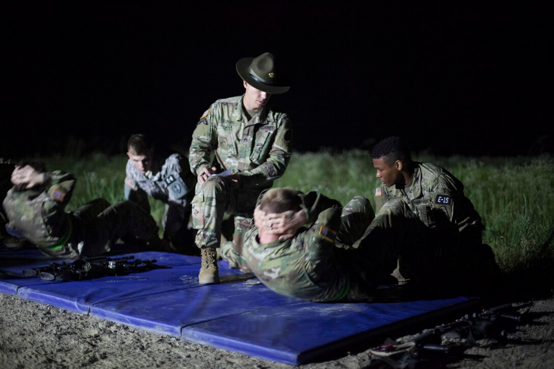 Staff Sgt. Colby Ford, a drill sergeant with A Company 1-354 Training Battalion the grades the sit-ups of a Warrior during a surprise Army Physical Fitness Test, at the 2017 U.S. Army Reserve Best Warrior Competition at Fort Bragg, N.C., June 13. This year's Best Warrior Competition will determine the top noncommissioned officer and junior enlisted Soldier who will represent the U.S. Army Reserve in the Department of the Army Best Warrior Competition later this year at Fort A.P. Hill, Va. (U.S. Army Reserve photo by Spc. Jesse L. Artis Jr.) (Released)