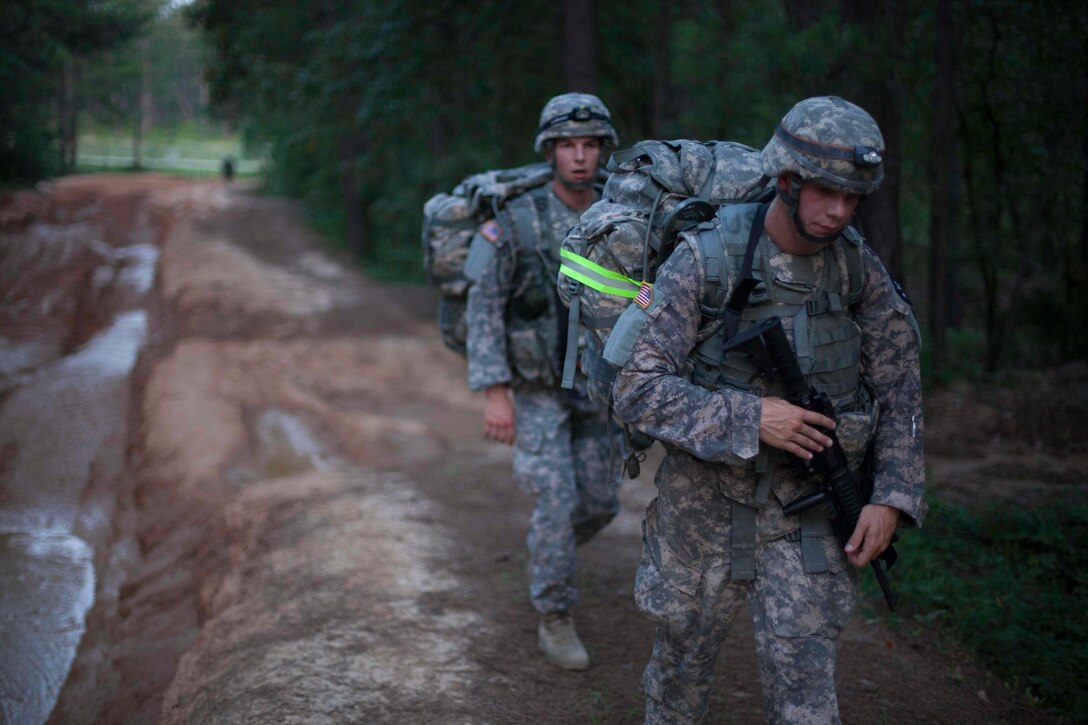Warriors maneuver through muddy terrain during Foot March, at the 2017 U.S. Army Reserve Best Warrior Competition at Fort Bragg, N.C., June 13. This year's Best Warrior Competition will determine the top noncommissioned officer and junior enlisted Soldier who will represent the U.S. Army Reserve in the Department of the Army Best Warrior Competition later this year at Fort A.P. Hill, Va. (U.S. Army Reserve photo by Spc. Jesse L. Artis Jr.) (Released)