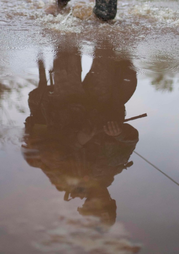 A Warrior wade his way through water as he competes in Foot March, at the 2017 U.S. Army Reserve Best Warrior Competition at Fort Bragg, N.C., June 13. This year's Best Warrior Competition will determine the top noncommissioned officer and junior enlisted Soldier who will represent the U.S. Army Reserve in the Department of the Army Best Warrior Competition later this year at Fort A.P. Hill, Va. (U.S. Army Reserve photo by Spc. Jesse L. Artis Jr.) (Released)