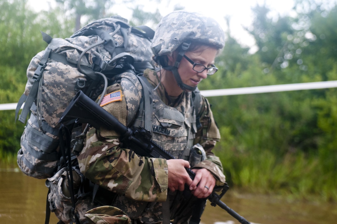 Spc. Katie Nadeau a healthcare specialist representing the 3rd Medical Command Deployment Support, crosses water during a 10-kilometer foot march at the 2017 U.S. Army Reserve Best Warrior Competition at Fort Bragg, N.C. June 13. This year's Best Warrior Competition will determine the top noncommissioned officer and junior enlisted Soldier who will represent the U.S. Army Reserve in the Department of the Army Best Warrior Competition later this year at Fort A.P. Hill, Va. (U.S. Army Reserve photo by Trenton Fouche) (Released)