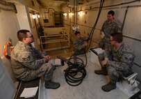 Members of the 91st Missile Maintenance Squadron missile maintenance team inspect a hoist at Minot Air Force Base, N.D., May 30, 2017. The five-member Global Strike Challenge 2017 maintenance team inspected payload transporter hoists to ensure they can properly lift missile components. (U.S. Air Force photo/Airman 1st Class Jonathan McElderry)