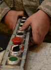 A member of the 91st Missile Maintenance Squadron missile maintenance team tests a hoist pendant at Minot Air Force Base, N.D., May 30, 2017. To prepare for Global Strike Challenge 2017, the five-member maintenance team inspected and tested various components of a payload transporter. (U.S. Air Force photo/Airman 1st Class Jonathan McElderry)