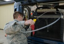 Senior Airman Damien White, 91st Missile Maintenance Squadron missile maintenance team member, inspects a vehicle’s engine oil at Minot Air Force Base, N.D., May 30, 2017. These Airmen performed fuel-water separator inspections to help prepare for Global Strike Challenge 2017. (U.S. Air Force photo/Airman 1st Class Jonathan McElderry)
