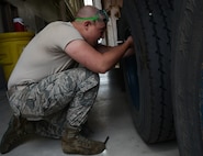 Senior Airman Allen Farmer, 91st Missile Maintenance Squadron missile maintenance team member, checks a tire’s air pressure at Minot Air Force Base, N.D., May 30, 2017. The missile maintenance team performed payload transporter inspections to help them train for Global Strike Challenge 2017. (U.S. Air Force photo/Airman 1st Class Jonathan McElderry)