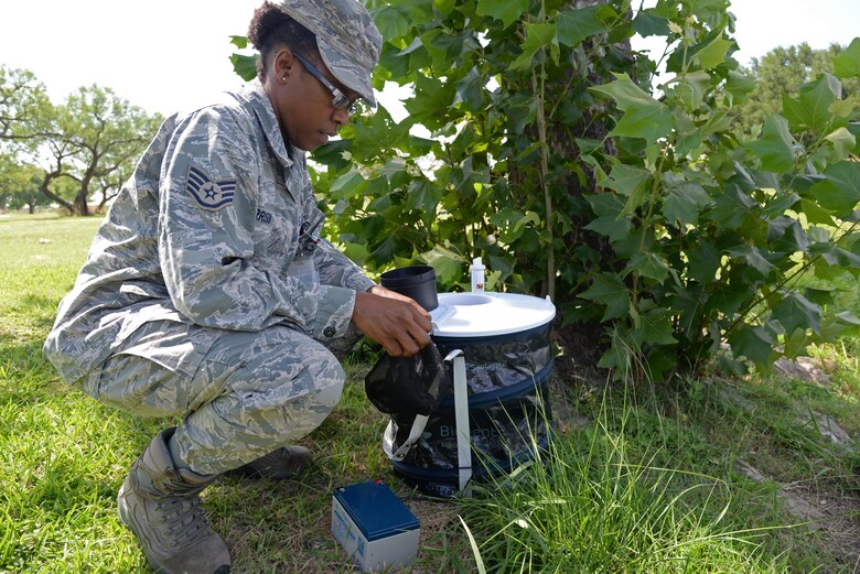 Staff Sgt. Natasha Morrison, 47th Medical Operations Squadron Public Health NCO in charge, places a mosquito trap by the pond at Leaning Pines Golf Course at Laughlin Air Force Base, Jun 14, 2017.  Laughlin has no recorded incidents of mosquito bites harboring the Zika Virus on base, but tests are freuqently performed between May and October to keep the Laughlin human population safe. (U.S. Air Force phto/Airman 1st Class Daniel Hambor)