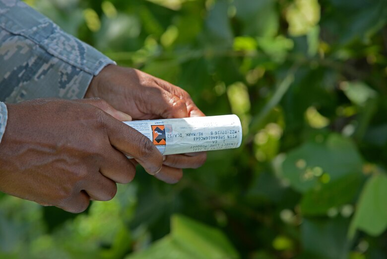 Staff Sgt. Natasha Morrison, 47th Medical Operations Squadron Public Health NCO in charge, unwraps a “sweat stick” near the pond at Leaning Pines Golf Course at Laughlin Air Force Base, June 14, 2017.  The “sweat stick” attracts Laughlin’s mosquito population to the trap upon catching the scent. (U.S. Air Force photo/Airman 1st Class Daniel Hambor)