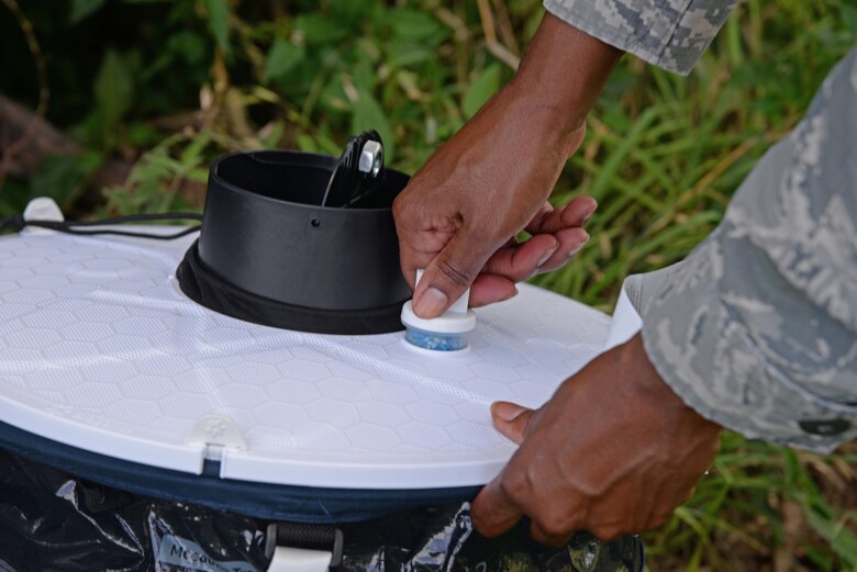 Staff Sgt. Natasha Morrison, 47th Medical Operations Squadron Public Health NCO in charge, pushes a “sweat stick” into a mosquito trap at Laughlin Air Force Base, June 14, 2017.  The battery-powered trap wafts a scent of sweat inside the trap to attract mosquitos, which will be tested at Wright-Patterson Air Force Base for any traces of Zika and any other mosquito-transferred virus. (U.S. Air Force Phto/Airman 1st Class Daniel Hambor)