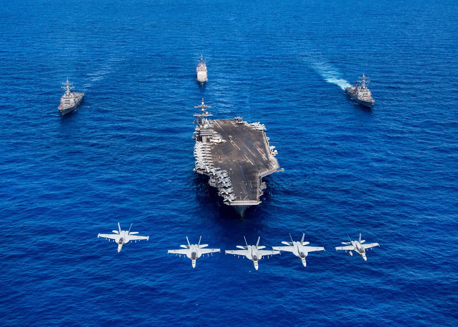 F/A-18 Hornets and Super Hornets from Carrier Air Wing (CVW) Two fly over Nimitz-class aircraft carrier USS Carl Vinson (CVN 70), front, Arleigh Burke-class guided-missile destroyers USS Wayne E. Meyer (DDG 108), right, and USS Michael Murphy (DDG 112), left, and Ticonderoga-class guided-missile cruiser USS Lake Champlain (CG 57) transit the Pacific Ocean, June 12, 2017. The U.S. Navy has patrolled the Indo-Asia-Pacific routinely for more than 70 years promoting regional peace and security.