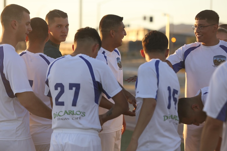 Headquarters Battalion brings it in for a team chant during half time against 1st Tank Battalion in the intramural soccer championship game at Felix Field aboard the Marine Corps Air Ground Combat Center, Twentynine Palms, Calif., June 12, 2017. Marine Corps Community Services, Semper Fit, hosts an intramural soccer league for units aboard the installation. Tanks came out victorious with a score of 2-1. (U.S. Marine Corps photo by Lance Cpl. Christian Lopez)