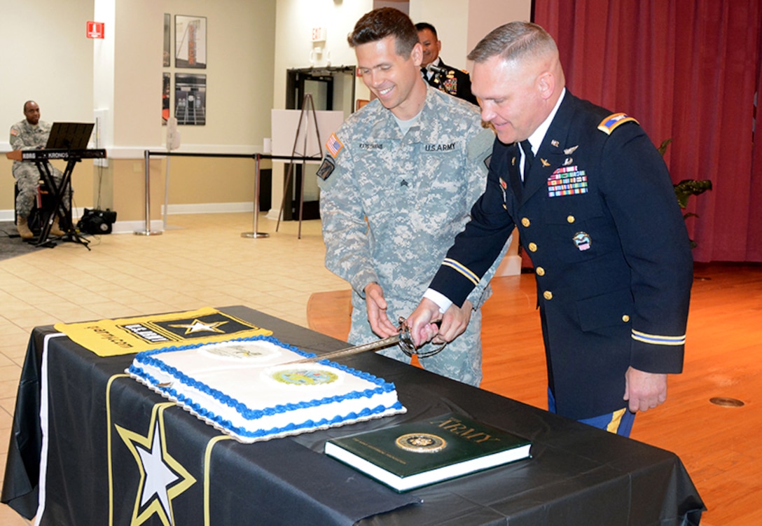 Defense Logistics Agency Aviation’s Col. Mark Hirschinger, chief, Army Customer Facing Division, Customer Operations Directorate, cuts the Army birthday cake June 13, 2017 with Sgt. Tom Katsiyiannis, 392nd Army Band, Fort Lee, Virginia, at Defense Supply Center Richmond, Virginia. The cake ceremony is a long standing Army tradition where the soldier with longest time in service cuts the cake with the soldier with the least amount of time in service using the ceremonial military saber.