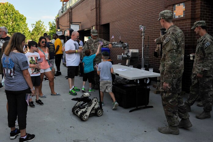 Members of the 628th Civil Engineer Squadron Explosive Ordnance Disposal Flight display a bomb disposal robot during the Charleston RiverDogs Military Appreciation Night at Joseph P. Riley Jr. Park, Charleston, June 14, 2017. The Joint Base Charleston Honor Guard, the 841st Transportation Battalion and 628th Security Forces Squadron represented JB Charleston at the game. The RiverDogs beat the West Virginia Power 5-2.