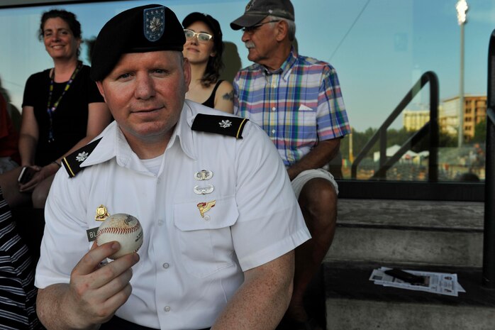 U.S. Army Lt. Col. Chad Blacketer, 841st Transportation Battalion commander, displays his baseball after throwing the ceremonial first pitch during the Charleston RiverDogs Military Appreciation Night at Joseph P. Riley Jr. Park, Charleston, June 14, 2017. The Joint Base Charleston Honor Guard, 628th Security Forces Squadron and 628th Civil Engineer Squadron Explosive Ordnance Disposal Flight also represented JB Charleston at the game. The RiverDogs beat the West Virginia Power 5-2.