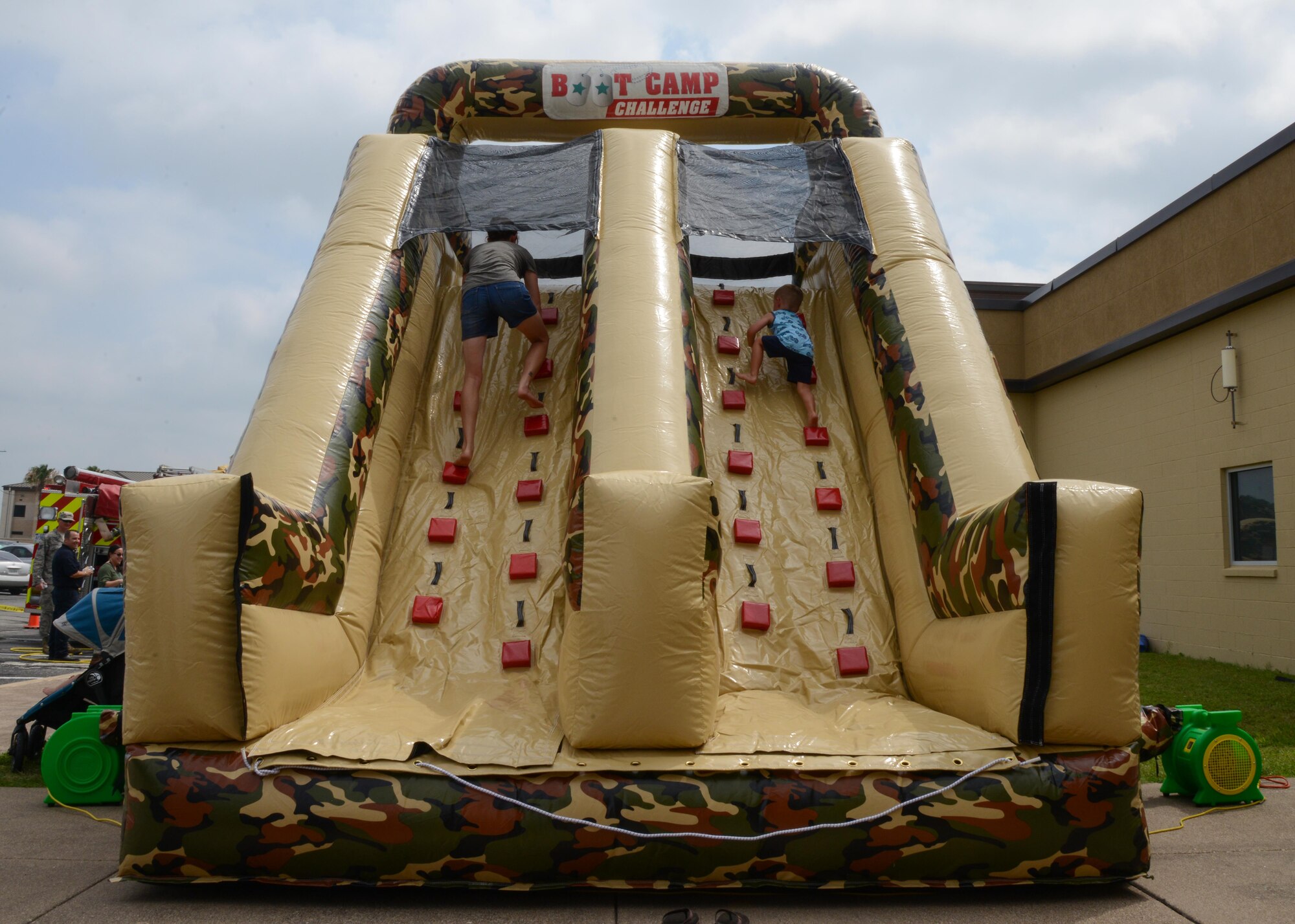 Healthy Lifestyle Festival attendees take on the obstacle course at Laughlin Air Force Base, June 13, 2017. The obstacle course, provided by the 47th Force Support Squadron, gave parents a chance to let their children exercise during the festival. (U.S. Air Force photo/ Airman 1st Class Benjamin N. Valmoja)