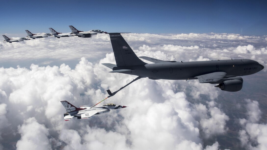 A KC-135 Stratotanker aircraft, right, fuels an F-16 Fighting Falcon assigned to the Thunderbirds, while the Thunderbirds fly to Nellis Air Force Base, Nev., June 12, 2017. The Thunderbirds, the Air Force’s air demonstration squadron, are based at Nellis. Air Force photo by Tech. Sgt. Christopher Boitz